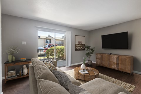 A living room with a large couch and a flat screen TV.
